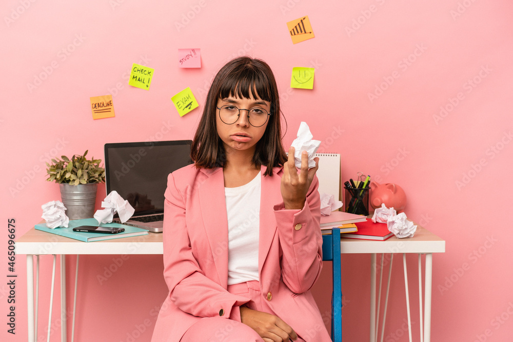 Young mixed race woman preparing a exam in the room holding a paper isolated on pink background Young mixed race woman preparing a exam in the room holding a paper isolated on pink background