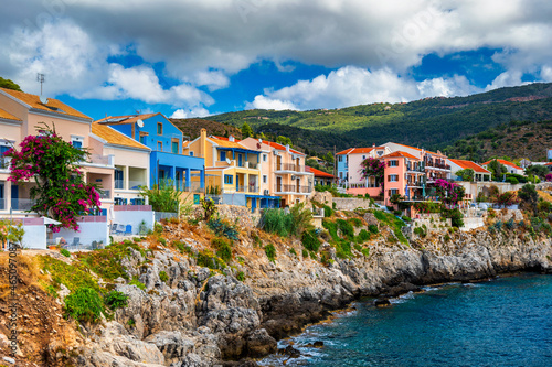Turquoise colored bay in Mediterranean sea with beautiful colorful houses in Assos village in Kefalonia, Greece. Town of Assos with colorful houses on the mediterranean sea, Greece. © daliu