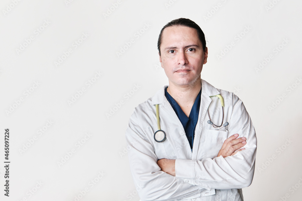 serious latin doctor, crossing his arms on white background with stethoscope serious latin doctor, crossing his arms on white background with stethoscope
