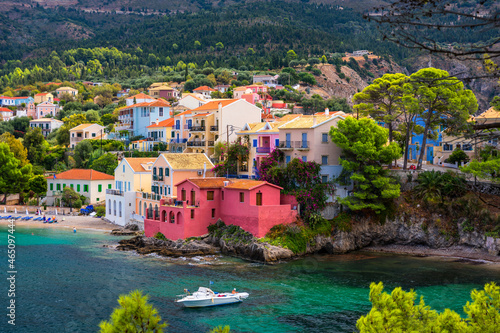 Assos village in Kefalonia, Greece. Turquoise colored bay in Mediterranean sea with beautiful colorful houses in Assos village in Kefalonia, Greece, Ionian island, Cephalonia, Assos village.