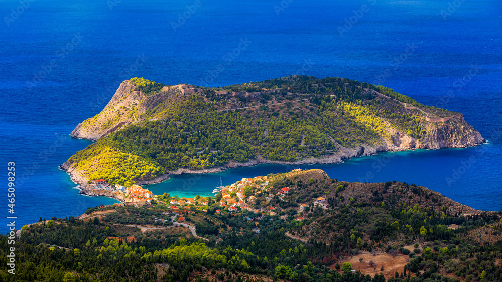 Naklejka premium Assos village in Kefalonia, Greece. Turquoise colored bay in Mediterranean sea with beautiful colorful houses in Assos village in Kefalonia, Greece, Ionian island, Cephalonia, Assos village.