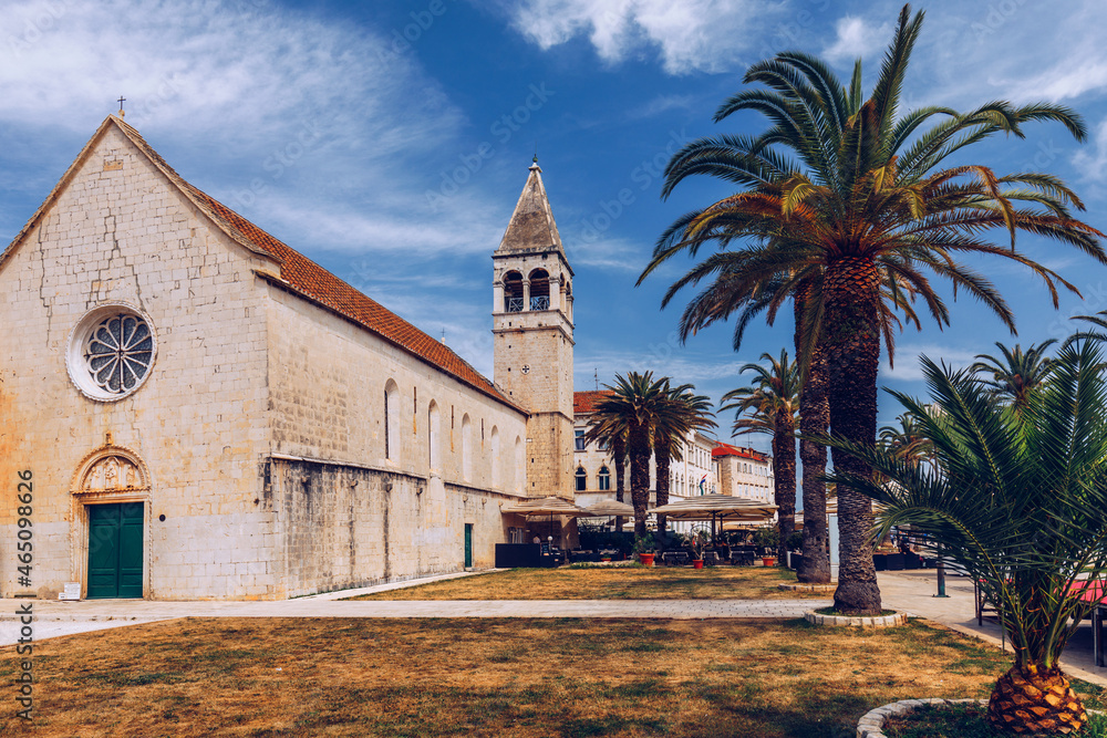 Obraz premium Historic buildings on promenade in Trogir, Croatia. Trogir is popular travel destination in Croatia. Trogir, as a UNESCO World Heritage Site, is one of most visited places in Dalmatia, Croatia.