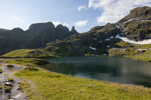 Amazing hiking day in one of the most beautiful area in Switzerland called Pizol in the canton of Saint Gallen. What a wonderful landscape in Switzerland at a sunny day. Beautiful blue alpine lake. photo