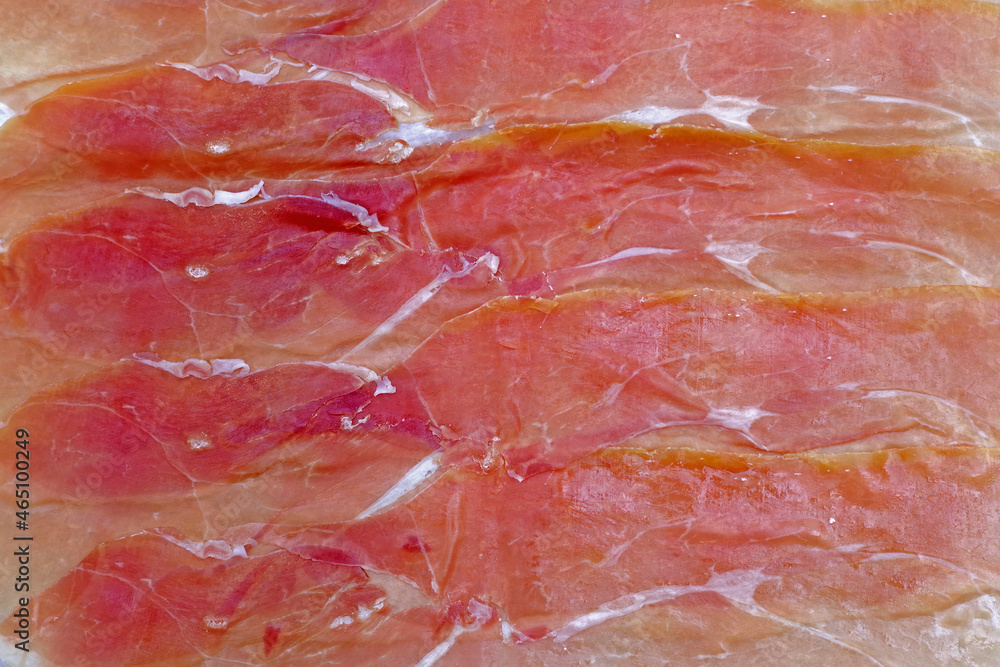 Full frame close-up view of layers of thin sliced prosciutto di Parma Full frame close-up view of layers of thin sliced prosciutto di Parma