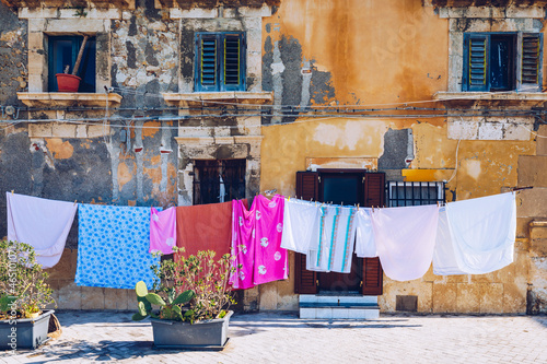 Siracusa (Syracuse) in a sunny summer day. Sicily, Italy. The clothes being dried in the narrow street of the famous historic town Syracuse, Sicily. © daliu