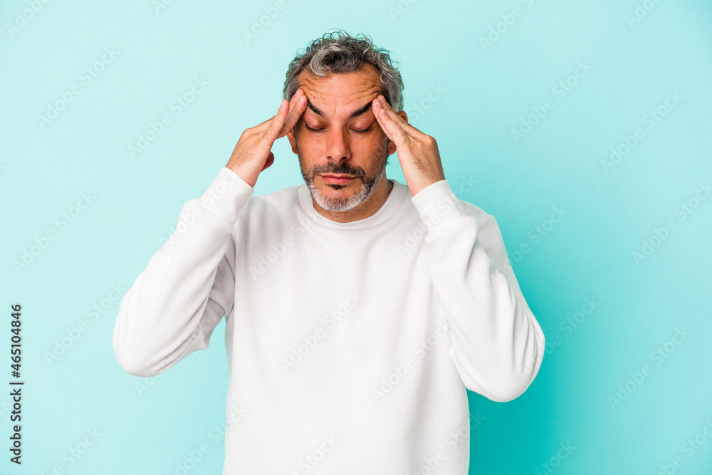 Middle age caucasian man isolated on blue background touching temples and having headache. Middle age caucasian man isolated on blue background touching temples and having headache.