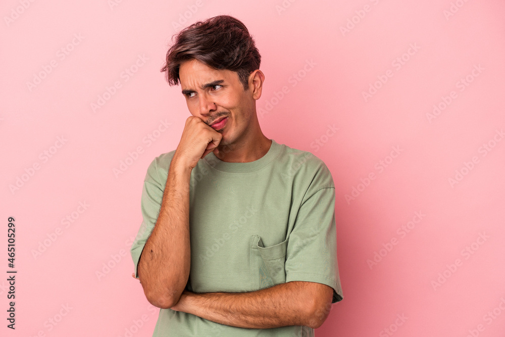 Young mixed race man isolated on white background who feels sad and pensive, looking at copy space. Young mixed race man isolated on white background who feels sad and pensive, looking at copy space.