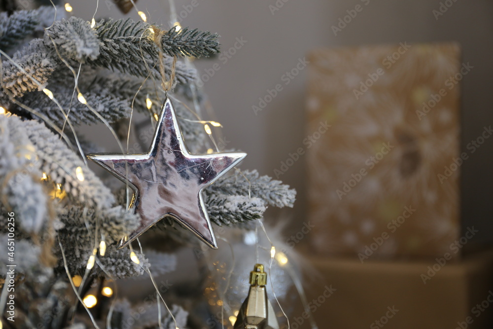 elegant Christmas tree with gifts in the living room with textured gray walls in luxury apartments elegant Christmas tree with gifts in the living room with textured gray walls in luxury apartments