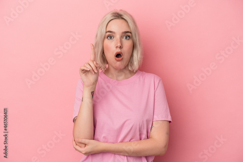 Young caucasian woman isolated on pink background having some great idea, concept of creativity.