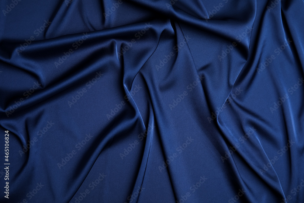 Obraz premium Crumpled dark blue silk fabric as background, top view
