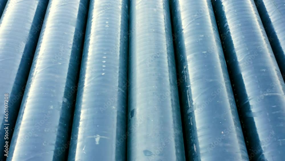 Abstract view of stacked PVC pipes resembling series of ribs ...