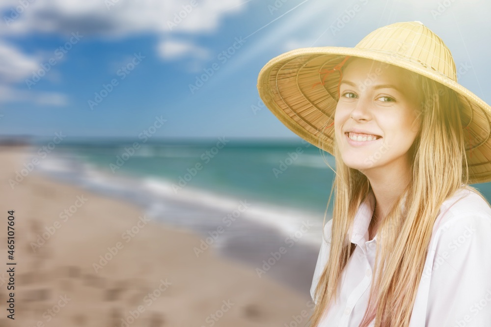 Happy young woman feeling the breeze at beach.