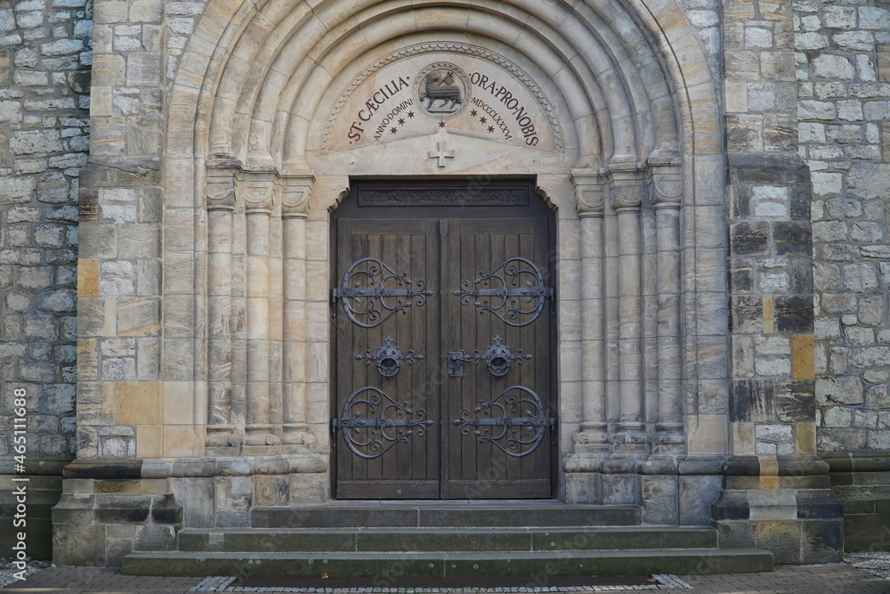 Fototapeta premium Entrance portal to the catholic parish church Saint Caecilia from 1886 in the municipality of Harsum, a village in the district of Hildesheim, in Lower Saxony, Germany.