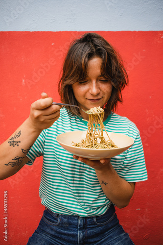 young woman eating pasta cute girl eating spaghetti having fun delicious food photography