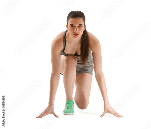 Sporty young woman in crouc...