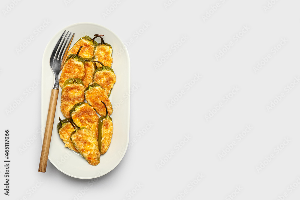 Plate with tasty jalapeno poppers on white background Plate with tasty jalapeno poppers on white background