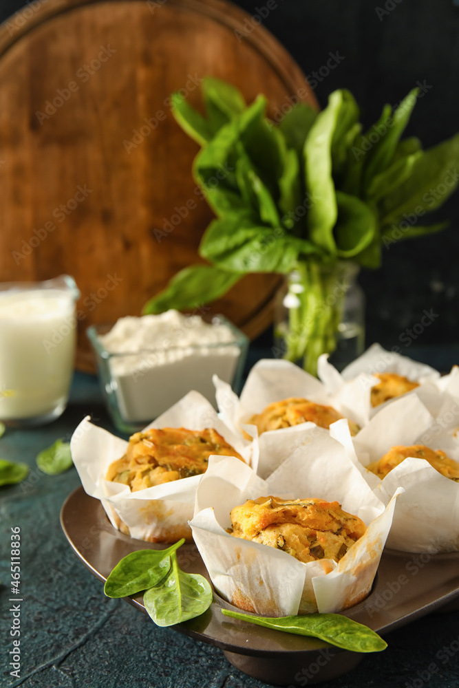 Baking tin with tasty spinach muffins on dark background Baking tin with tasty spinach muffins on dark background