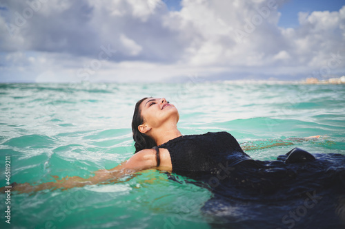 Smiling woman relaxing in clear sea © Daniel