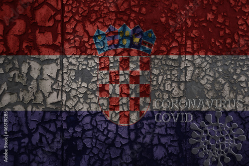 flag of croatia on a old metal rusty cracked wall with text coronavirus, covid, and virus picture.