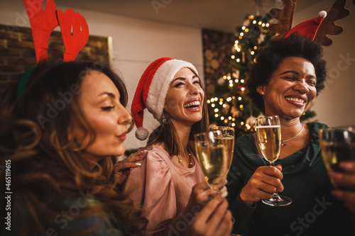 Multiethnic Female Friends Having Fun And Making Toast As During Christmas Party At Home