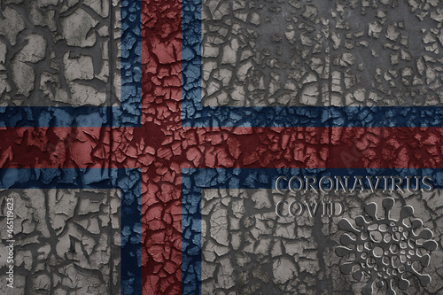 flag of faroe islands on a old metal rusty cracked wall with text coronavirus, covid, and virus picture.