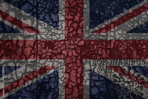 flag of great britain on a old metal rusty cracked wall with text coronavirus, covid, and virus picture.