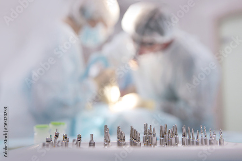Wallpaper Mural Dental instruments for installing implants close-up. The figures of doctors are blurred. Out of focus. Modern dentistry. Free space or background. Torontodigital.ca