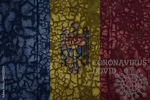 flag of moldova on a old metal rusty cracked wall with text coronavirus, covid, and virus picture.