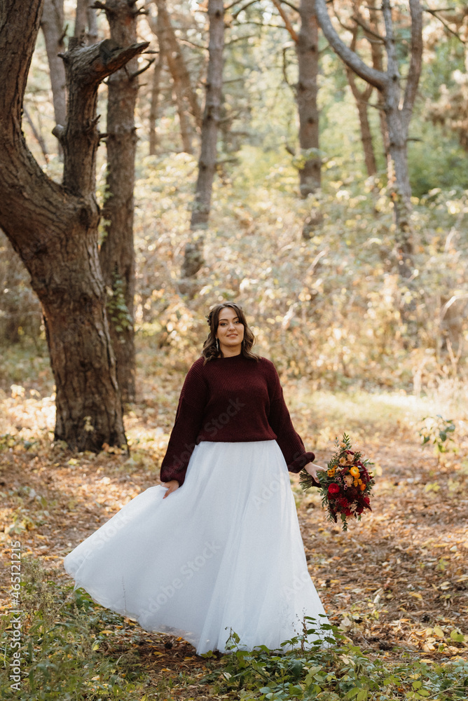 girl in a wedding dress in the autumn forest