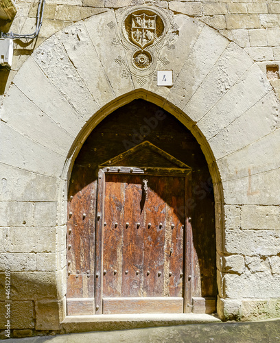 Old deteriorated wooden door in a neighborhood of Sos del Rey Catolico photo