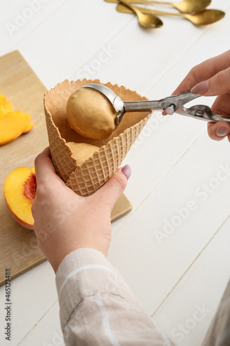 Woman preparing tasty peach...