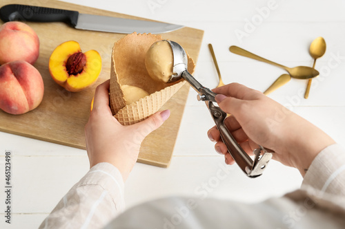 Woman preparing tasty peach...