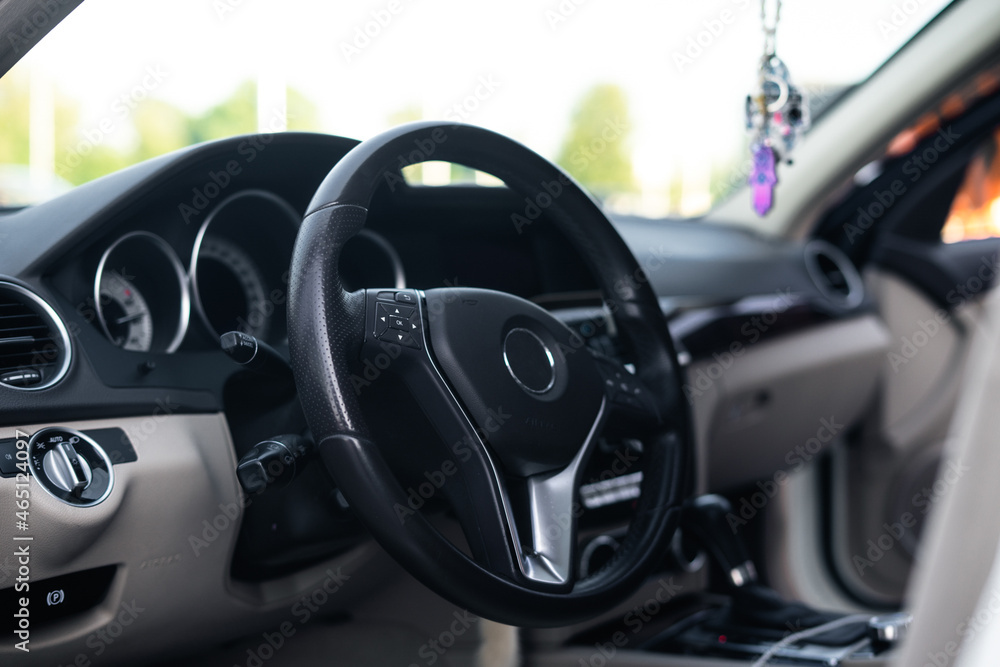 Steering wheel of a modern luxury car close up