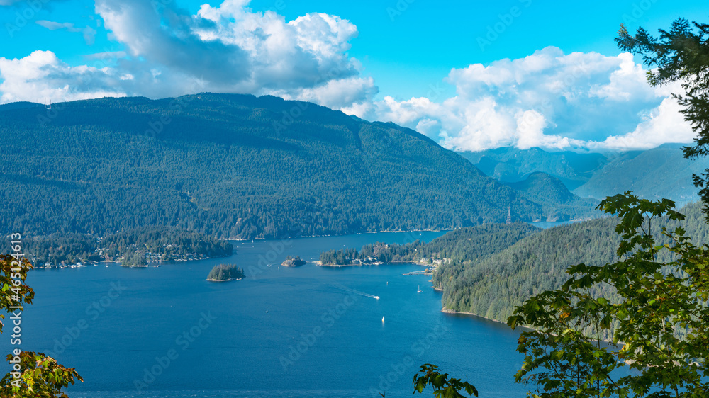 Cloud-capped and forest-clad mountains bordering pristine Burrard Inlet near Port Moody and Deep Cove, BC, Canada
