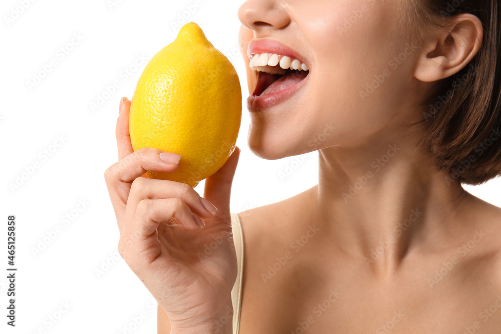 Young woman with lemon on white background, closeup. Vegan Day Young woman with lemon on white background, closeup. Vegan Day