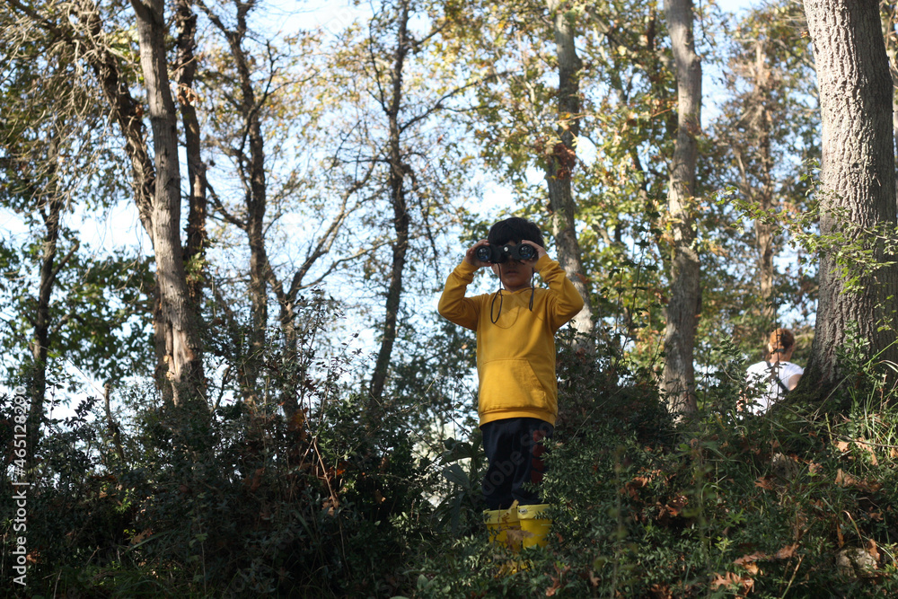 Adventurer boy playing with binoculars. Adventurer boy playing with binoculars.