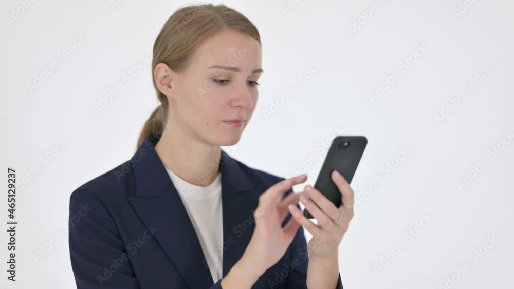 Young Businesswoman Browsing Smartphone on White Background Young Businesswoman Browsing Smartphone on White Background