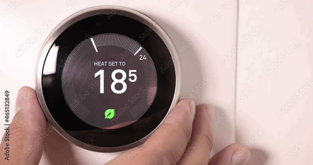 A person lowering the temperature on a Smart Thermostat on Celsios scale in slow motion A person lowering the temperature on a Smart Thermostat on Celsios scale in slow motion