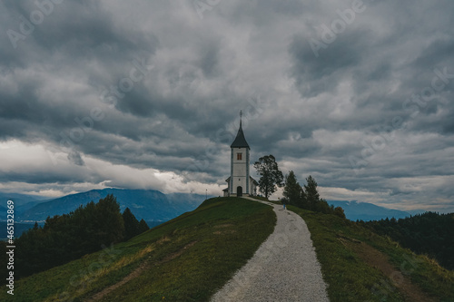 Lonely church before the big autumn rain. Slovenian Alps, Europe