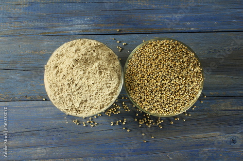 pearl millet grain whole and flour in bowl for indian gujarati food recipe as food background photo
