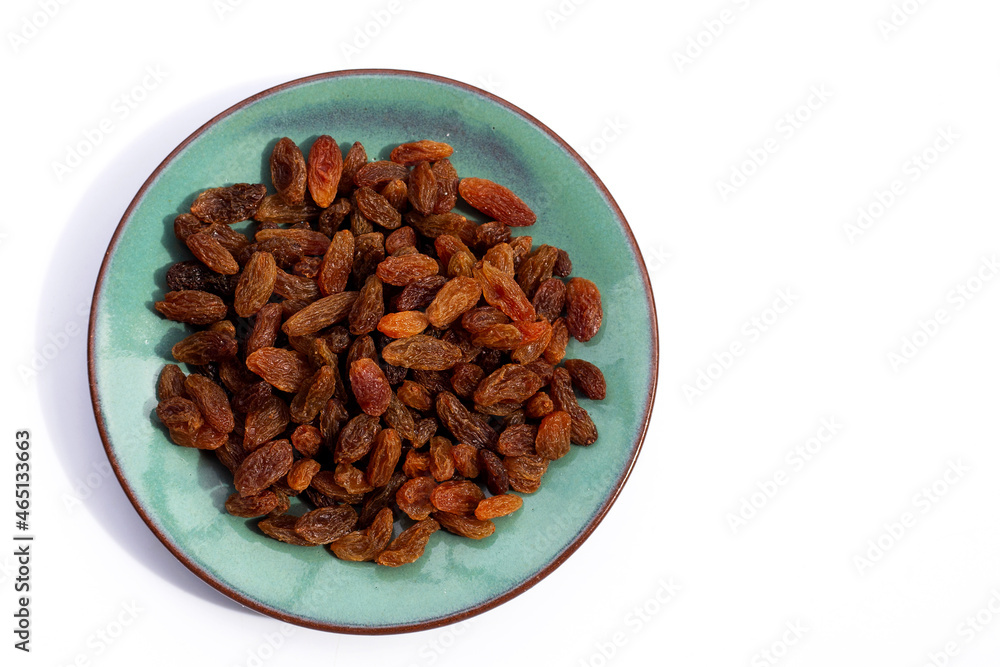 Dried grape raisins in plate on white background Dried grape raisins in plate on white background