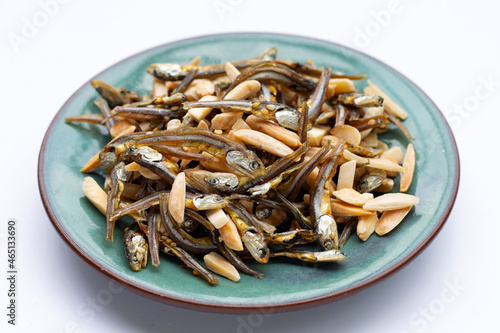 Almonds Mixed Anchovy in plate on white background.