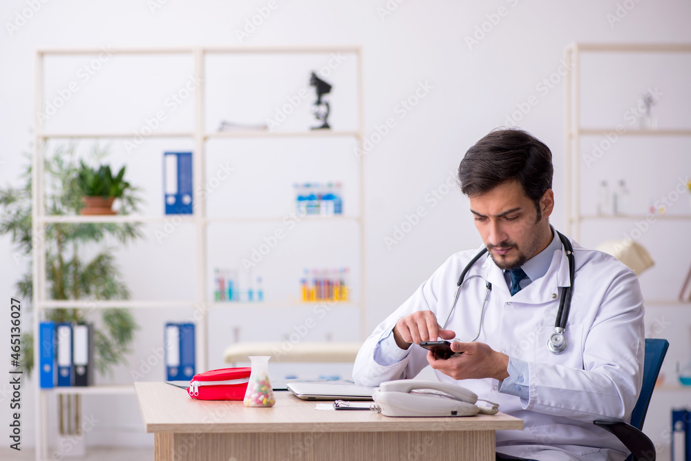 Young male doctor in telemedicine concept Young male doctor in telemedicine concept