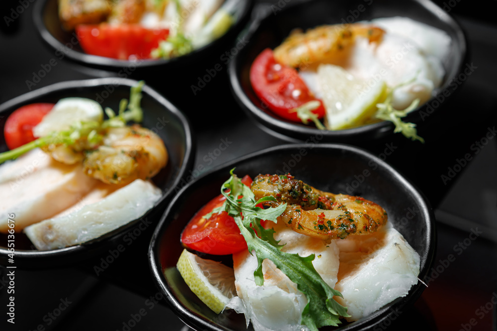 A light snack of shrimp, fish fillet, lemon, tomato and greens. A light snack of shrimp, fish fillet, lemon, tomato and greens.