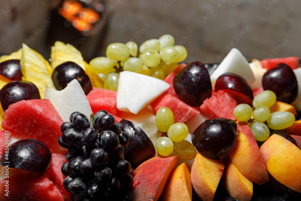 Grapes, sliced watermelon, melon, peaches close-up. Grapes, sliced watermelon, melon, peaches close-up.