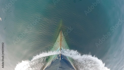 View from above. The bow of the ship is cut by the waves of the calm northern sea.