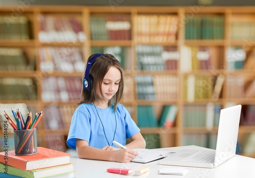Happy teen child school college students wear headphones learn looking at laptop