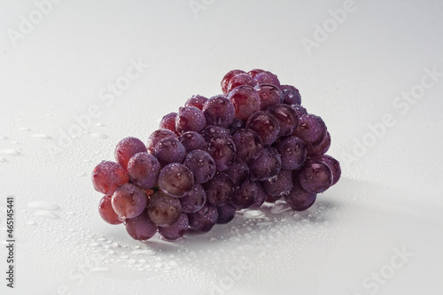 Uvas roxas frescas em fundo branco photo