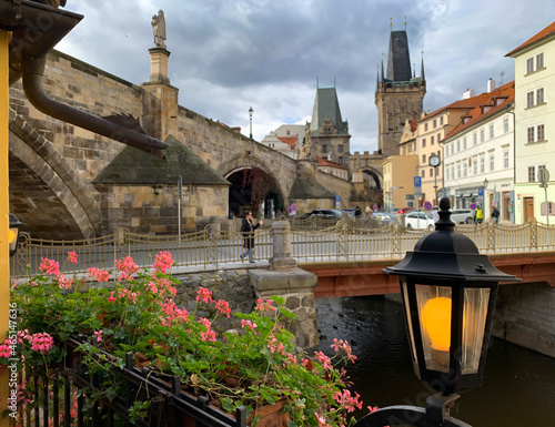 View of the bridge over the river Chertovka and Charles Bridge photo