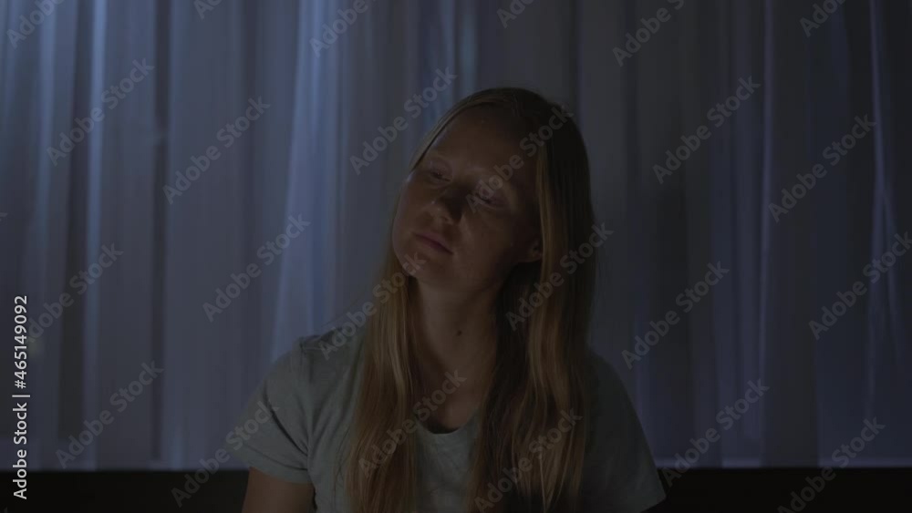 A woman at night turns on a meditation, relaxation application to relax before going to bed. Antistress apps. Healthy lifestyle. New normal A woman at night turns on a meditation, relaxation application to relax before going to bed. Antistress apps. Healthy lifestyle. New normal